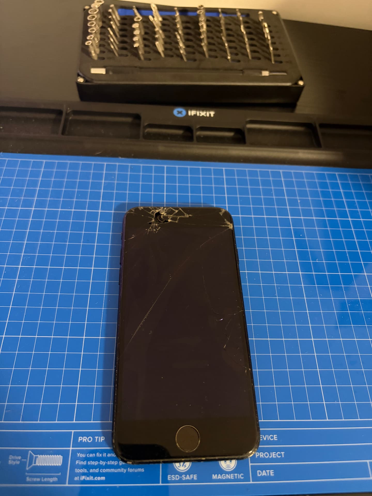 Smartphone with a badly cracked screen before repair